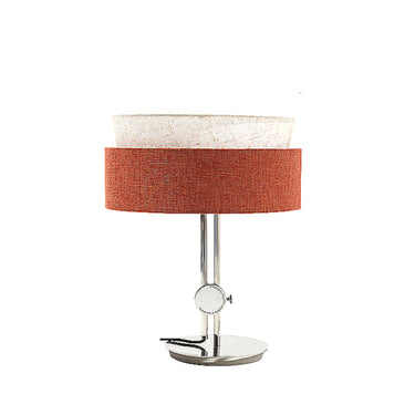 Modern table lamp with double layered white and orange fabric shades and sleek metal base