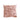 Pink decorative pillow with a textured leaf pattern on a white background