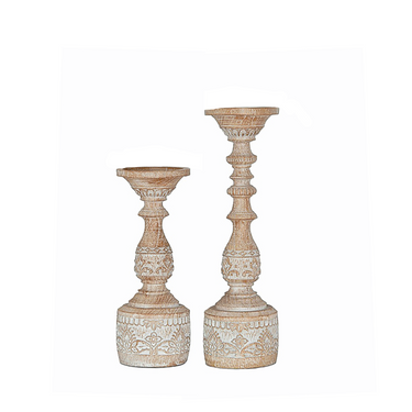 Two beige wooden candle stands with intricate patterns, one larger than the other, set against a white background.