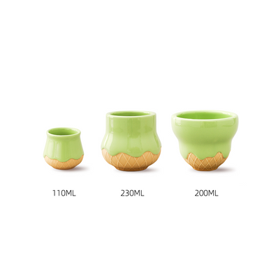 A set of three green ceramic cups with a geometric pattern on the lower part, displayed in a递增的顺序, dishwasher safe, microwavable.
