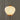 A Japanese-style paper lantern table lamp glowing with warm light, featuring a ribbed white paper shade, orange-brown wooden accents, and a black metal stand against a neutral gray background.