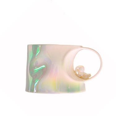 Iridescent ceramic mug with a unique wavy texture and a small decorative ring on handle