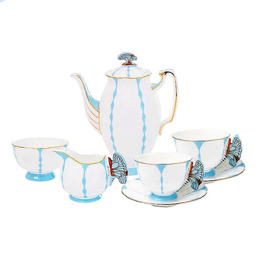 Elegant white porcelain tea set with blue accents and butterfly handles, including teapot, cups, and saucers