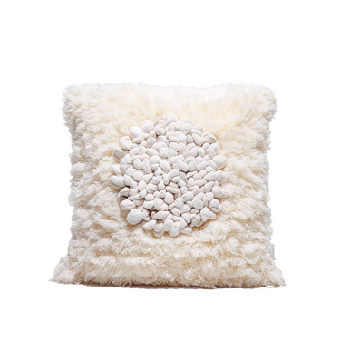 Cream fluffy decorative square pillow with textured knotted center for cozy home décor