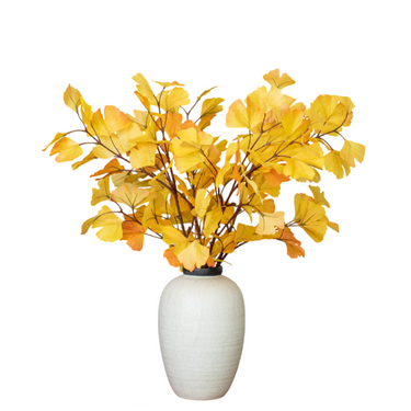 Elegant white ceramic vase with artificial yellow autumn ginkgo leaves, home décor accent