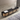 Long black console table with wicker doors in a modern room.