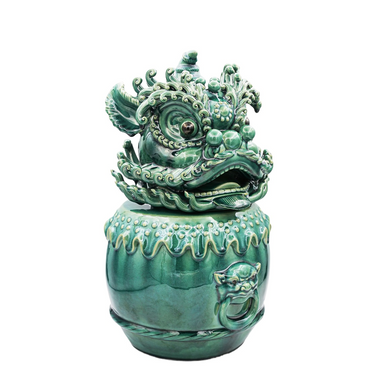 Green ceramic decorative sculpture featuring an intricate mythical creature head, ideal for home décor
