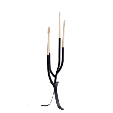 A black iron candle holder with a walnut base, featuring a minimalistic design with three upright iron legs and a horizontal stabilizer bar.