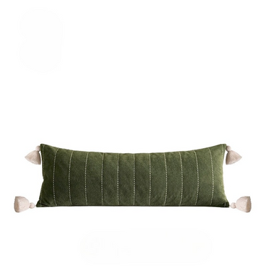Green striped pillow with tassels on a white background