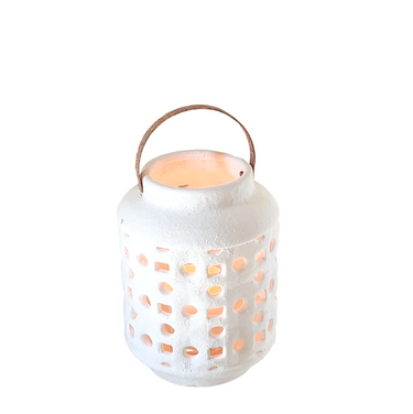 White ceramic lantern with square and round cutouts and wooden handle, softly lit from within