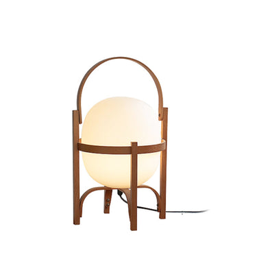 Table lamp with a wooden frame and glass shade on a white background