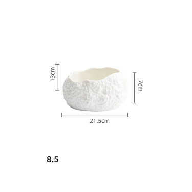 A white ceramic soup bowl with an irregular, textured exterior.