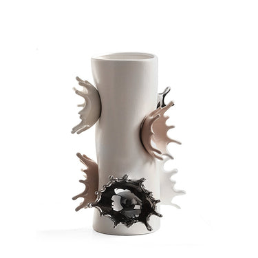 Modern ceramic vase with splash-shaped decorative accents in neutral and metallic colors