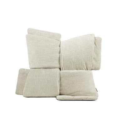 A set of six textured, ribbed fabric throw pillows in a light beige color, arranged in a stack on a white background. The brand logo 'bada 百搭家居' is visible in the top left corner, and a product code '产品编号:DB86064' is at the bottom.