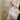 Person applying wallpaper with a decorative design featuring birds and flowers.