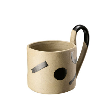 Beige mug with black handle and decorative elements on a white background