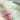 Close-up of a textured fabric with floral patterns and soft colors.