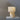 Table lamp with beige shade and base on a gray surface against a gray background