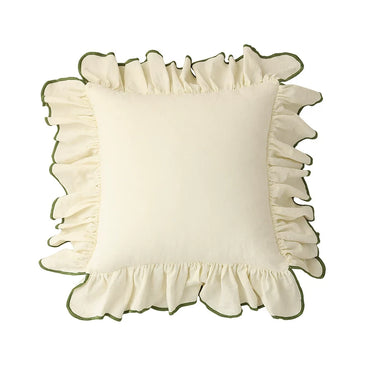 Cream-colored pillow with ruffled edges on a white background