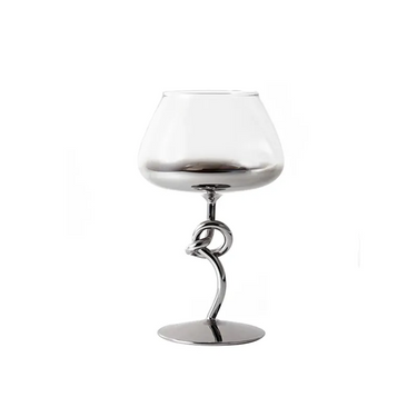 A clear glass tumbler with a silver knot-shaped base and a curved stand, placed against a white background.