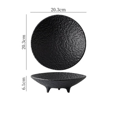 A white ceramic tripod plate with a textured surface and three legs, handcrafted in Japan.