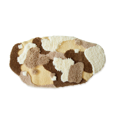 Oval fluffy area rug with abstract cream, brown, beige, and tan pattern for home décor