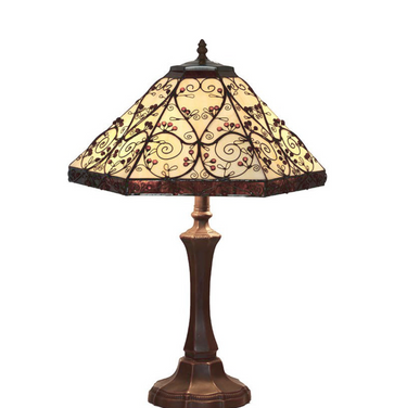 Elegant table lamp with ornate bronze base and stained glass shade featuring intricate vine patterns