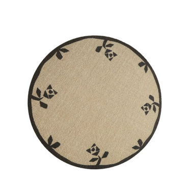 A round area rug with a floral pattern in black on a beige background.