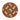 Round brown area rug with black, white, and dark brown polka dot pattern, modern home décor