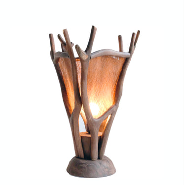 Rustic wooden table lamp with branch-style frame and warm fabric shade illuminating softly