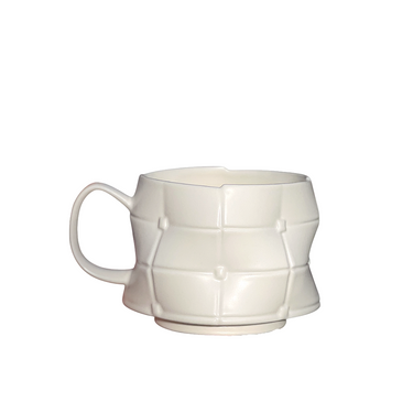 White ceramic mug with geometric pattern on a white background