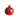A red ceramic vase with a pomegranate-like shape on a white background.