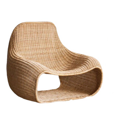 Modern curved rattan lounge chair with natural woven texture, minimalist home décor furniture