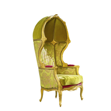 Vintage green and gold canopy armchair with ornate carved wooden frame and red velvet armrest accents
