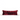 Red velvet pillow with white stripes and pom-pom accents on a white background