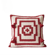Decorative pillow with red and white geometric pattern on a white background