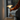 Person adjusting a table lamp on a desk with a blurred background