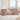 Beige sofa in a room with white walls and curtains