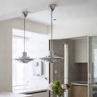 Modern kitchen interior with pendant lights and a vase of flowers.