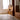 Modern floor lamp with geometric design in a room with wooden paneling and a window.